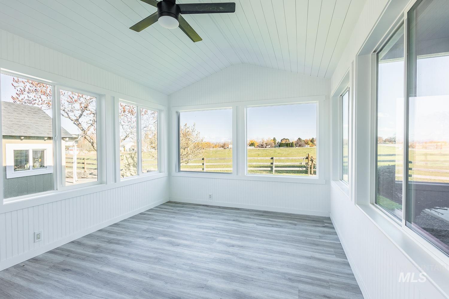 988 West King Road Kuna, ID 83634 - Photo 25 of 50 Unfurnished sunroom with plenty of natural light, wood finished floors, lofted ceiling, and wooden ceiling