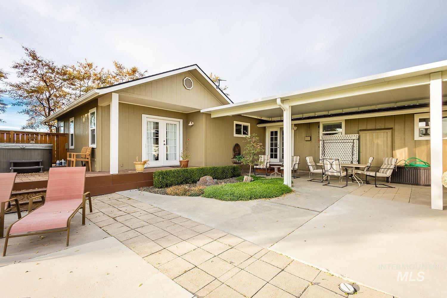 988 West King Road Kuna, ID 83634 - Photo 32 of 50 Rear view of property with a patio area, french doors, a hot tub, and outdoor dining space