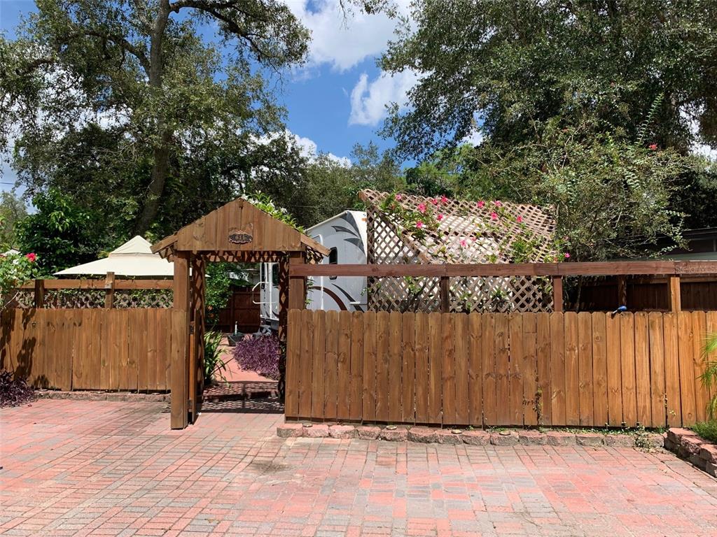 a street view with wooden fence and trees