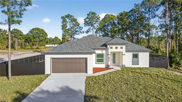 a front view of a house with a yard and garage