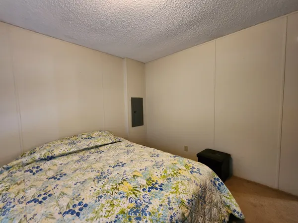a bedroom with a bed and a potted plant