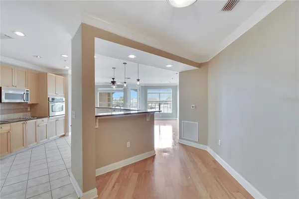 a kitchen with stainless steel appliances granite countertop a sink a stove and a granite counter tops with white countertops