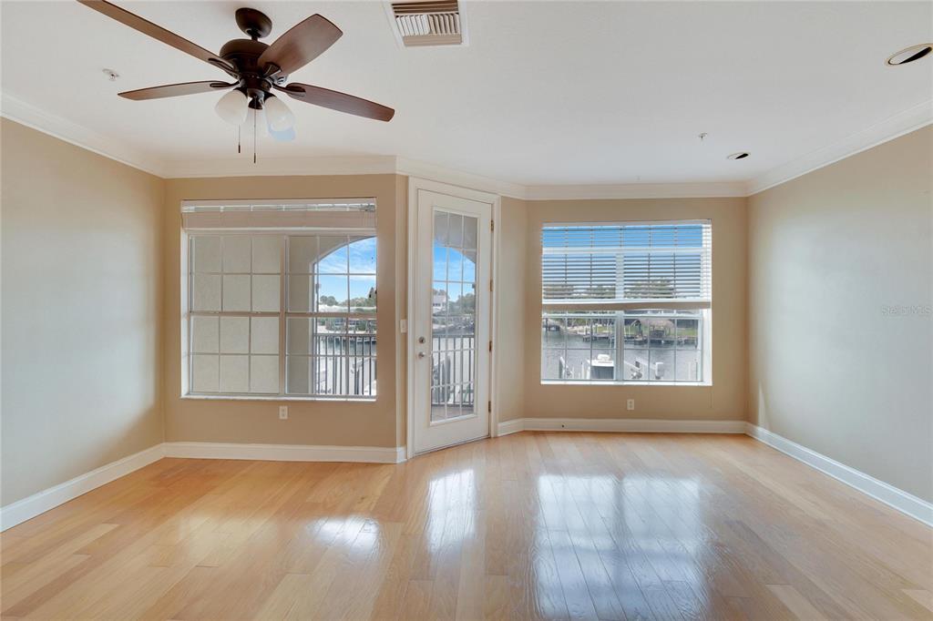 6414 Sunset Bay Circle Apollo Beach, FL 33572 - Photo 14 of 50 a view of an empty room with a window and wooden floor