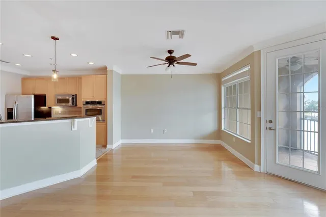 a large kitchen with a large counter top stainless steel appliances and cabinets