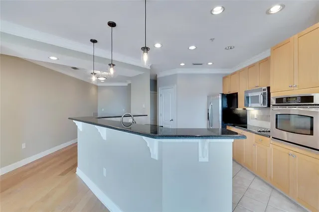 a kitchen with granite countertop cabinets and refrigerator
