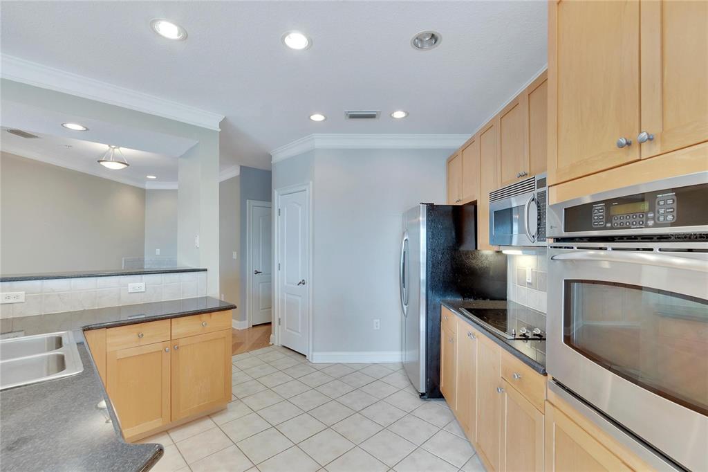6414 Sunset Bay Circle Apollo Beach, FL 33572 - Photo 21 of 50 a large kitchen with a large counter top stainless steel appliances and cabinets