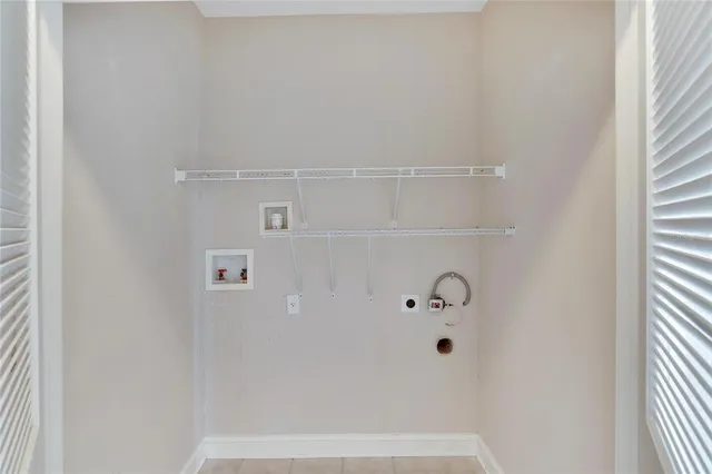 an empty room with closet and windows
