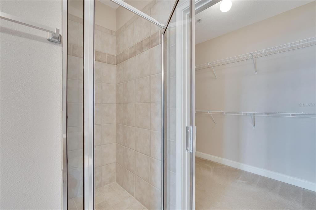 6414 Sunset Bay Circle Apollo Beach, FL 33572 - Photo 29 of 50 a bathroom with a glass shower door