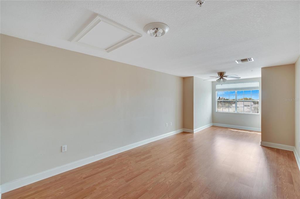 6414 Sunset Bay Circle Apollo Beach, FL 33572 - Photo 5 of 50 a view of a hallway with wooden floor and a refrigerator