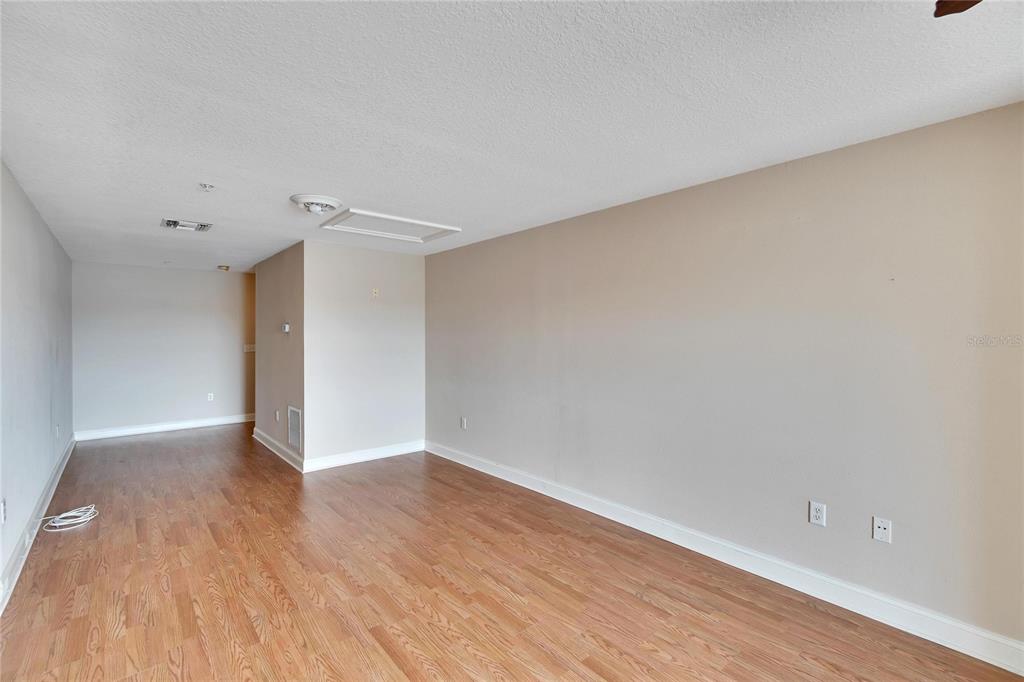 6414 Sunset Bay Circle Apollo Beach, FL 33572 - Photo 10 of 50 a view of an empty room with wooden floor