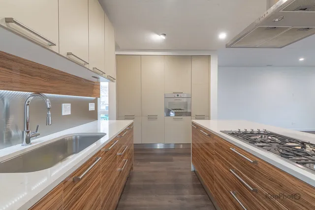 a kitchen with stainless steel appliances granite countertop a sink and cabinets