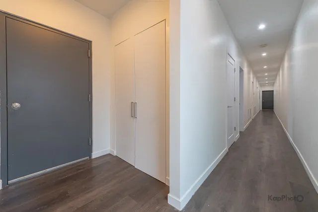 a view of a hallway with wooden floor