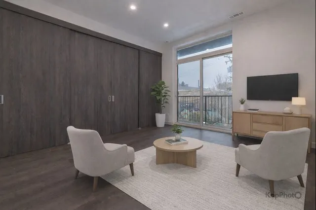 a living room with furniture a flat screen tv and a large window