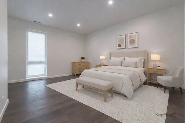 a spacious bedroom with a bed and a window