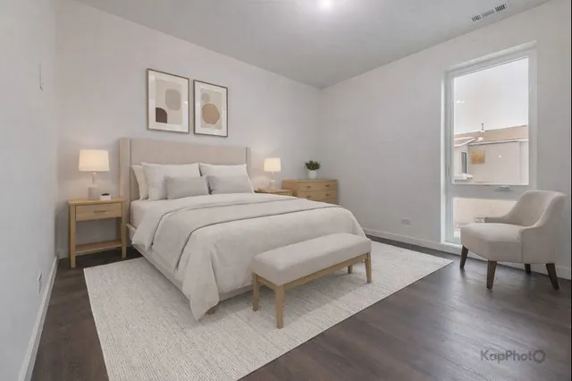 a bedroom with a bed and a chair