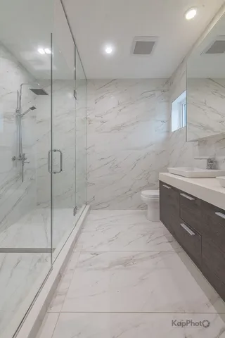 a bathroom with a shower and a sink