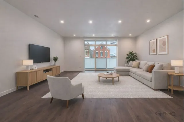 a living room with furniture a flat screen tv and a large window