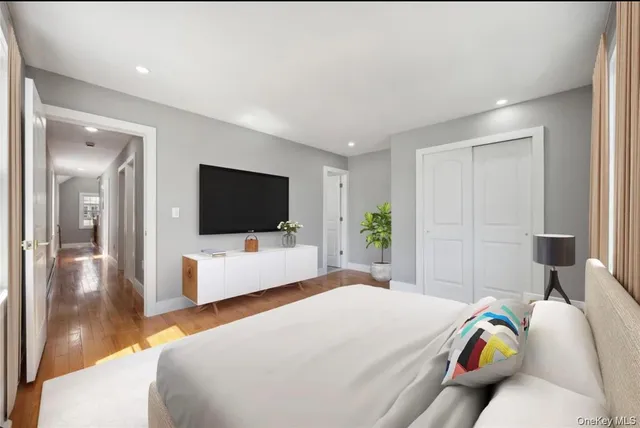 a bedroom with a bed and a flat screen tv