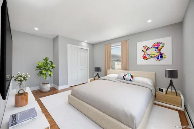 a bedroom with a bed and a potted plant