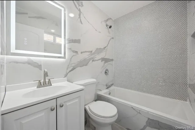 a bathroom with a sink a toilet and a bathtub