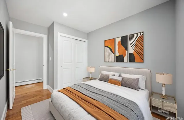 a bedroom with a bed and a painting on the wall