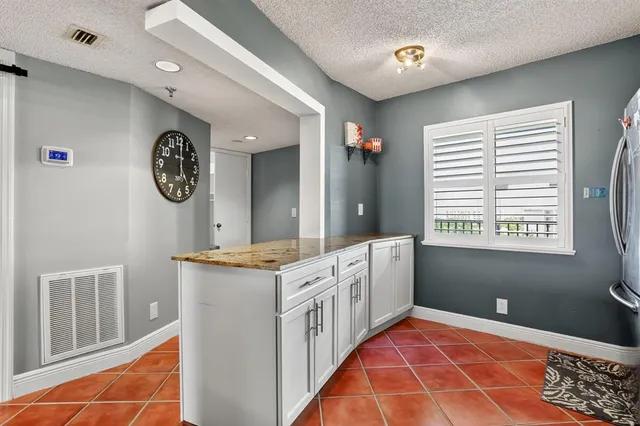 a kitchen with a stove a refrigerator a sink and a window