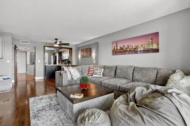 a living room with furniture and a dining table