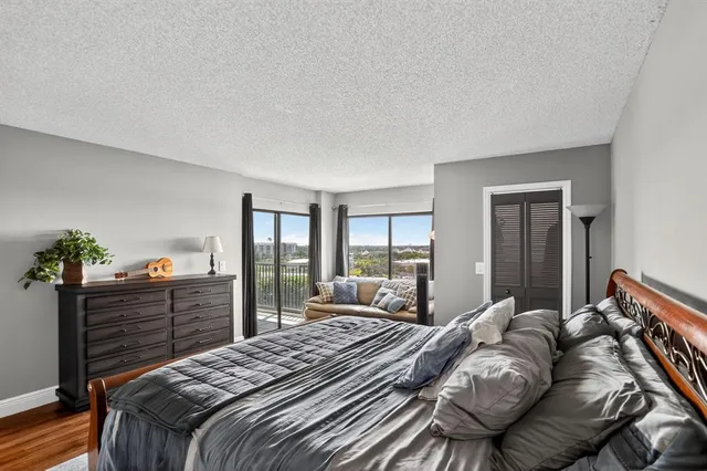 a bedroom with a bed and dresser with mirror