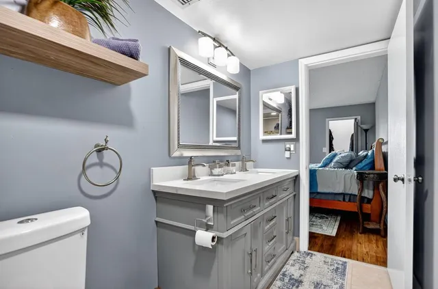 a bathroom with a toilet sink and mirror