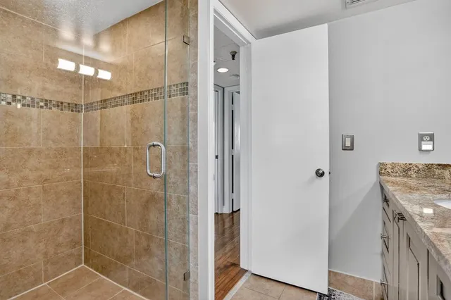 a bathroom with a shower and a sink
