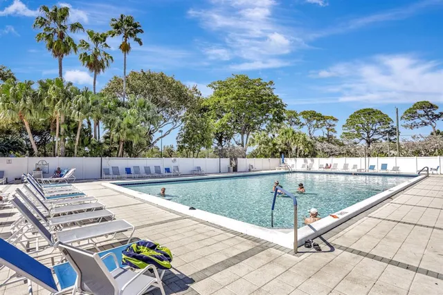 a view of a swimming pool with an outdoor seating