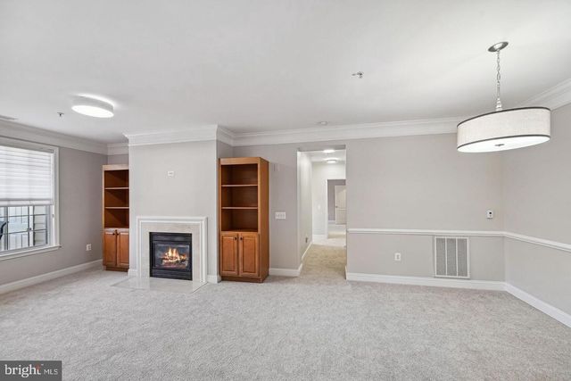 a view of a livingroom with a fireplace and window