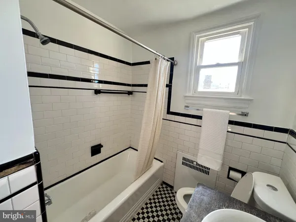 a bathroom with a bathtub and shower