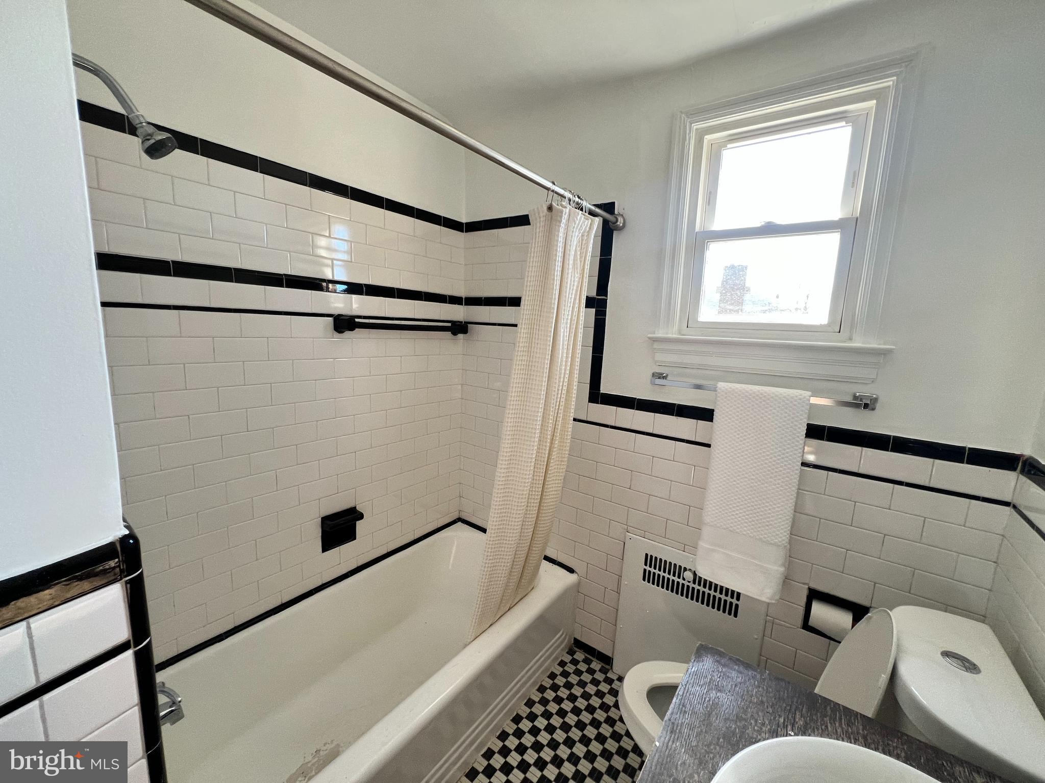 56 Yorkway Baltimore, MD 21222 - Photo 3 of 23 a bathroom with a bathtub and shower