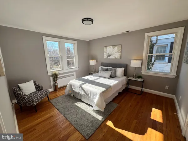 a bedroom with a bed lamp and a window