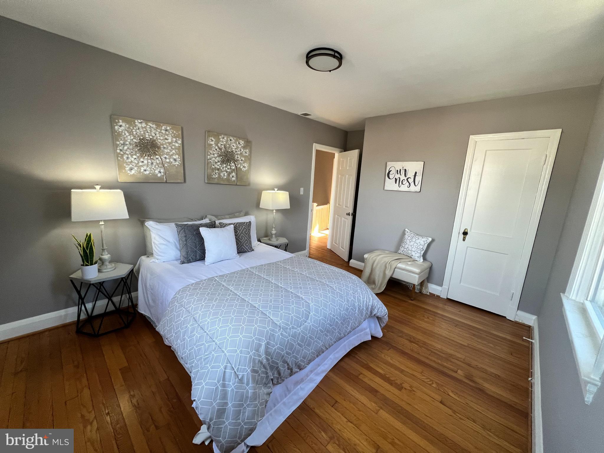 56 Yorkway Baltimore, MD 21222 - Photo 6 of 23 a bedroom with a bed and wooden floor