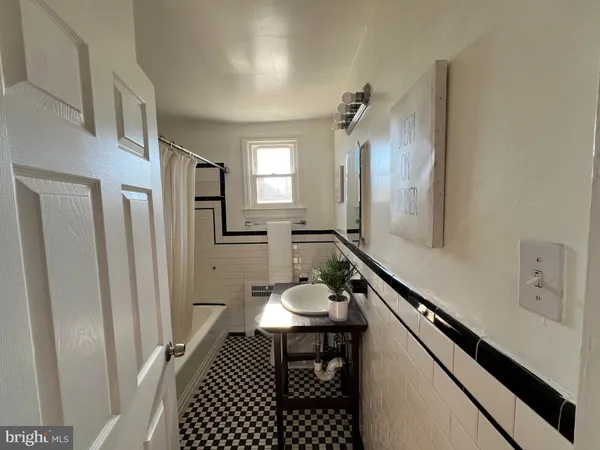 a bathroom with a sink a mirror a vanity and a shower