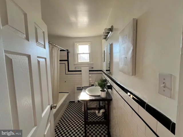 a bathroom with a sink a mirror a vanity and a shower