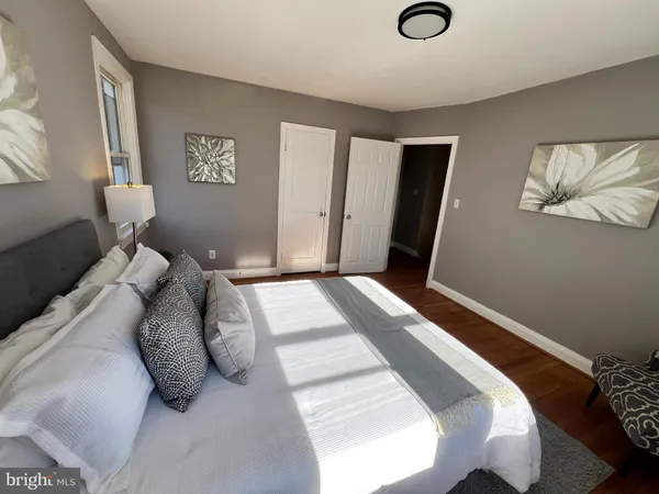a bedroom with a bed and a lamp