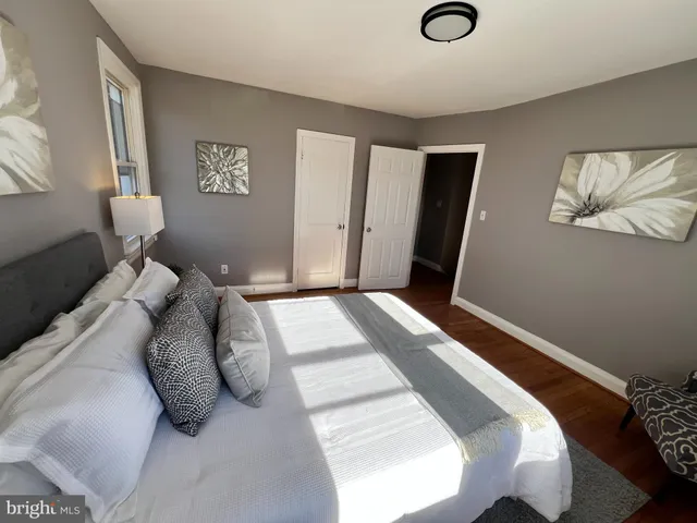 a bedroom with a bed and a lamp