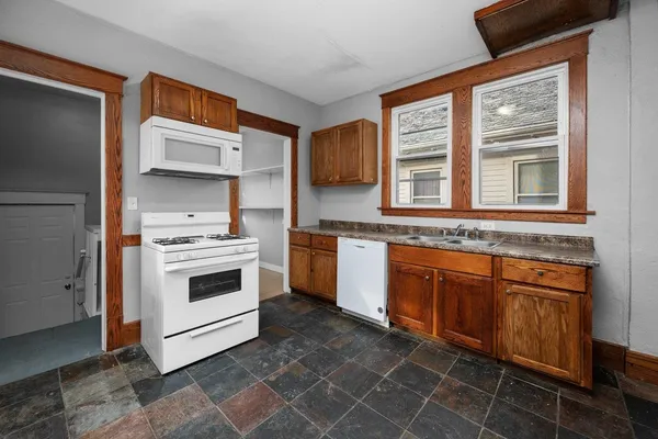 a kitchen with stainless steel appliances a stove a sink and a microwave