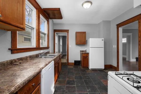 a kitchen with a sink stove and refrigerator