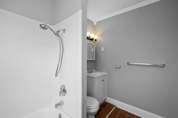 a bathroom with a shower a toilet and a sink