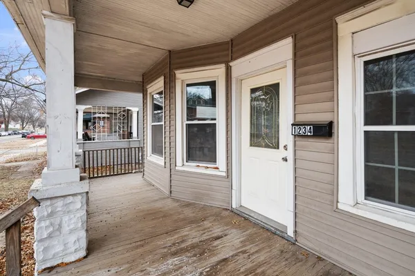 an entrance view of a house with a porch