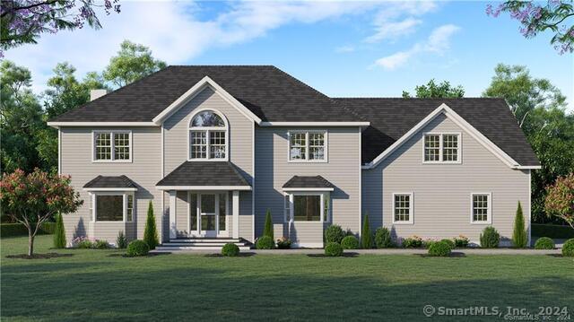 454 Horse Pond Road, Unit B Madison, CT 06443 - Photo 1 of 9 a front view of a house with a garden