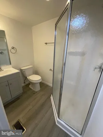 a bathroom with a toilet and a shower
