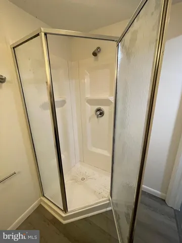 a bathroom with a glass door shower and sink