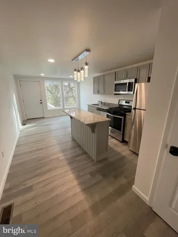 a kitchen with stainless steel appliances granite countertop a stove and a refrigerator