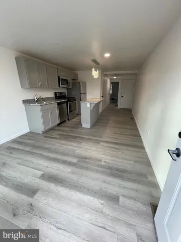 a view of kitchen with sink microwave and cabinets