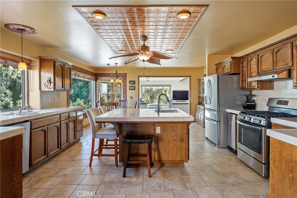 5145 Northfork Place Paso Robles, CA 93446 - Photo 16 of 62 a kitchen with stainless steel appliances granite countertop a sink and cabinets